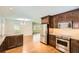 Open kitchen view with stainless steel appliances, granite counters, and hardwood floors flowing into the adjacent living area at 739 Pinehill Se Dr, Smyrna, GA 30080