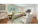 Comfortable living room with large windows, stylish furniture, and hardwood floors creating a relaxing and inviting atmosphere at 739 Pinehill Se Dr, Smyrna, GA 30080