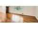 Spacious living room with gleaming hardwood floors and large windows providing abundant natural light and curb appeal at 739 Pinehill Se Dr, Smyrna, GA 30080