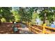 Scenic walking path with bench seating, a pond with a fountain, and wood fence at 739 Pinehill Se Dr, Smyrna, GA 30080