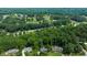 Aerial view of homes nestled amongst mature trees, showing proximity to golf course at 11785 Mountain Laurel Dr, Roswell, GA 30075