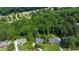 Aerial view of property nestled among mature trees, featuring lush landscaping and serene surroundings at 11785 Mountain Laurel Dr, Roswell, GA 30075