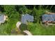 An aerial view of the home showcasing its mature landscaping and a private driveway leading to the property at 11785 Mountain Laurel Dr, Roswell, GA 30075