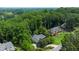 Expansive aerial view showcasing lush greenery, mature trees, and well-manicured lawns surrounding the home at 11785 Mountain Laurel Dr, Roswell, GA 30075