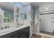 Charming bathroom with double vanity, walk-in shower, and delightful blue wave wallpaper at 11785 Mountain Laurel Dr, Roswell, GA 30075