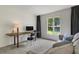 Bedroom with gray carpet and great lighting, with a sofa and desk for study or relaxation at 11785 Mountain Laurel Dr, Roswell, GA 30075