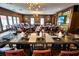Elegant dining room with a long table set for a formal gathering, featuring modern lighting and stylish decor at 11785 Mountain Laurel Dr, Roswell, GA 30075