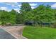 Well maintained home and lawn with circular driveway and mature shade trees on a sunny day at 11785 Mountain Laurel Dr, Roswell, GA 30075