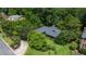Lovely home with mature trees and landscaping, featuring a driveway leading to the residence at 11785 Mountain Laurel Dr, Roswell, GA 30075
