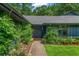 Charming front entrance with double doors, beautiful landscaping, and well-maintained lawn at 11785 Mountain Laurel Dr, Roswell, GA 30075