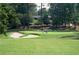 Well-maintained golf course with sand traps and lush green fairways surrounded by tall trees at 11785 Mountain Laurel Dr, Roswell, GA 30075