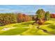 Picturesque golf course view showcasing lush green fairways, sand traps, and mature trees in a serene setting at 11785 Mountain Laurel Dr, Roswell, GA 30075
