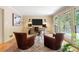 Well-lit home office with desk, chairs, and French doors leading to the outside at 11785 Mountain Laurel Dr, Roswell, GA 30075