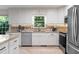 Bright kitchen featuring white cabinets, stainless appliances, and granite counters at 11785 Mountain Laurel Dr, Roswell, GA 30075