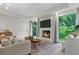 Bright main bedroom with fireplace, sitting area, and nature views at 11785 Mountain Laurel Dr, Roswell, GA 30075