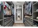 Spacious walk-in closet featuring custom shelving, drawers, and a full-length mirror to the bedroom at 11785 Mountain Laurel Dr, Roswell, GA 30075