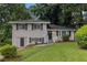 Charming home with brick facade, complemented by a lush green lawn and mature trees at 2083 Green Forrest Dr, Decatur, GA 30032