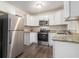 Modern kitchen featuring stainless steel appliances, granite countertops, and white cabinets at 2083 Green Forrest Dr, Decatur, GA 30032
