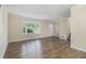 Bright living room featuring hardwood floors, large window, and staircase entrance at 2083 Green Forrest Dr, Decatur, GA 30032