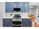 Modern kitchen featuring stainless steel appliances, white countertops, and dark blue cabinets at 2412 Boulder Se Rd, Atlanta, GA 30316
