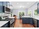 Bright, modern kitchen featuring stainless steel appliances, white countertops and blue cabinets at 2412 Boulder Se Rd, Atlanta, GA 30316