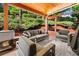 Inviting covered patio with comfortable seating, wood ceiling, and lush greenery, creating a relaxing outdoor living space at 2412 Boulder Se Rd, Atlanta, GA 30316