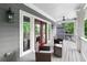 Charming porch with wicker seating, and red french doors, perfect for enjoying the outdoors at 2412 Boulder Se Rd, Atlanta, GA 30316