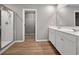 Modern bathroom with double vanity, glass-enclosed shower, and access to the walk-in closet at 301 Amsterdam Way, Hampton, GA 30228