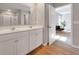 Bright bathroom with a double vanity and a view into a well-lit bedroom at 301 Amsterdam Way, Hampton, GA 30228