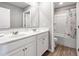 Bright bathroom features a double sink vanity and a shower-tub combo at 301 Amsterdam Way, Hampton, GA 30228