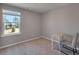 Bedroom with a window and neutral carpeting and paint at 301 Amsterdam Way, Hampton, GA 30228