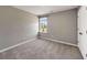 Cozy bedroom offers natural light from the large window and neutral carpeting at 301 Amsterdam Way, Hampton, GA 30228