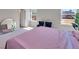Spacious bedroom featuring a large round mirror, carpet, and bright natural light at 301 Amsterdam Way, Hampton, GA 30228