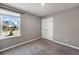 Bedroom with carpet, window, double door closet, and neutral paint at 301 Amsterdam Way, Hampton, GA 30228