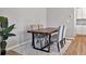 Bright dining area featuring a wood table, four chairs, and natural light at 301 Amsterdam Way, Hampton, GA 30228