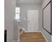 Inviting foyer featuring stairs, wood floors, and neutral paint color at 301 Amsterdam Way, Hampton, GA 30228