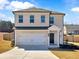 Beautiful two-story home with a brick facade, two-car garage, and manicured front yard, ready to move in at 301 Amsterdam Way, Hampton, GA 30228