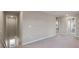 Hallway features neutral paint and carpeting and a stairwell to the left at 301 Amsterdam Way, Hampton, GA 30228