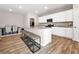 A kitchen with white cabinets, stainless steel appliances, and granite countertops at 301 Amsterdam Way, Hampton, GA 30228