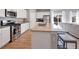 Open-concept kitchen features a spacious island, stainless steel appliances, and ample counter space at 301 Amsterdam Way, Hampton, GA 30228