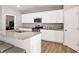 Kitchen boasts stainless steel appliances, granite countertops, and plenty of cabinet space at 301 Amsterdam Way, Hampton, GA 30228
