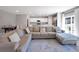 Bright open-concept living room with access to the kitchen, dining area, and outdoor patio at 301 Amsterdam Way, Hampton, GA 30228