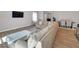 Bright living room boasts hardwood floors, a sectional sofa, and a large television at 301 Amsterdam Way, Hampton, GA 30228