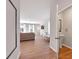 Open living room featuring hardwood floors, large windows, and a powder room for convenience at 301 Amsterdam Way, Hampton, GA 30228