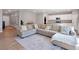 Spacious living room features neutral paint, a large sectional sofa, and easy access to the kitchen at 301 Amsterdam Way, Hampton, GA 30228