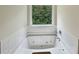 Relaxing bathroom showcases a luxurious soaking tub beneath a window at 3517 Mortons Landing Dr, Ellenwood, GA 30294