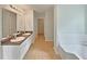Bright bathroom with double vanity, tile floors, and a separate tub at 3517 Mortons Landing Dr, Ellenwood, GA 30294