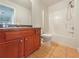 Bright bathroom features a vanity with storage and a clean, white shower-tub combination at 3517 Mortons Landing Dr, Ellenwood, GA 30294