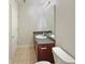 Neutral bathroom showcases a vanity, a large mirror, and a tiled floor at 3517 Mortons Landing Dr, Ellenwood, GA 30294