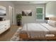 Staged bedroom with neutral walls, carpet, and a picture window offering natural light at 3517 Mortons Landing Dr, Ellenwood, GA 30294